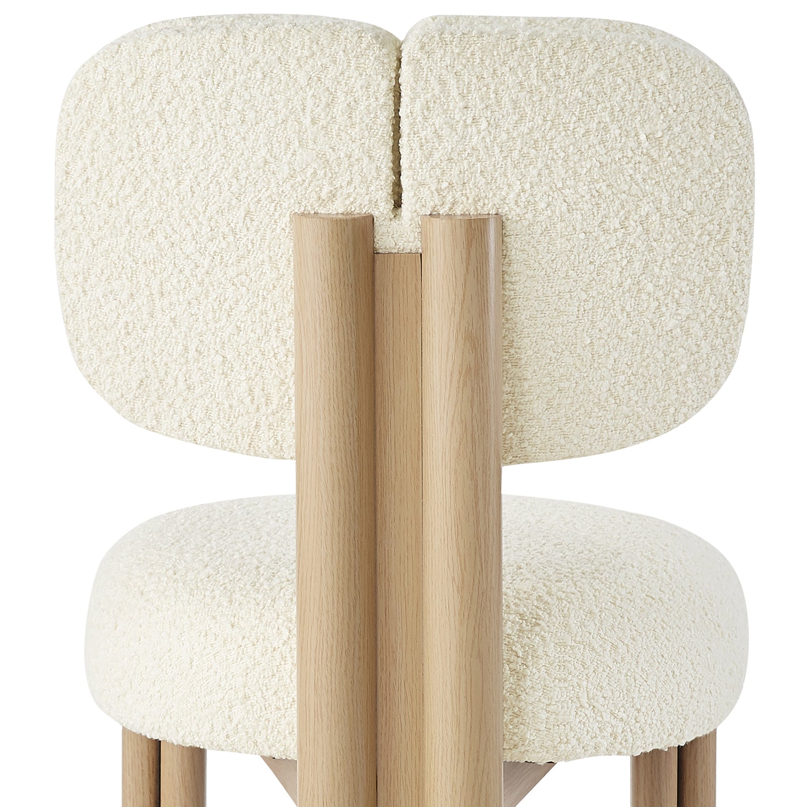 Norii Boucle Fabric Dining Chair in Cream White features a rounded backrest and seat in textured bouclé, supported by sleek light wood legs, offering modern elegance and comfort.