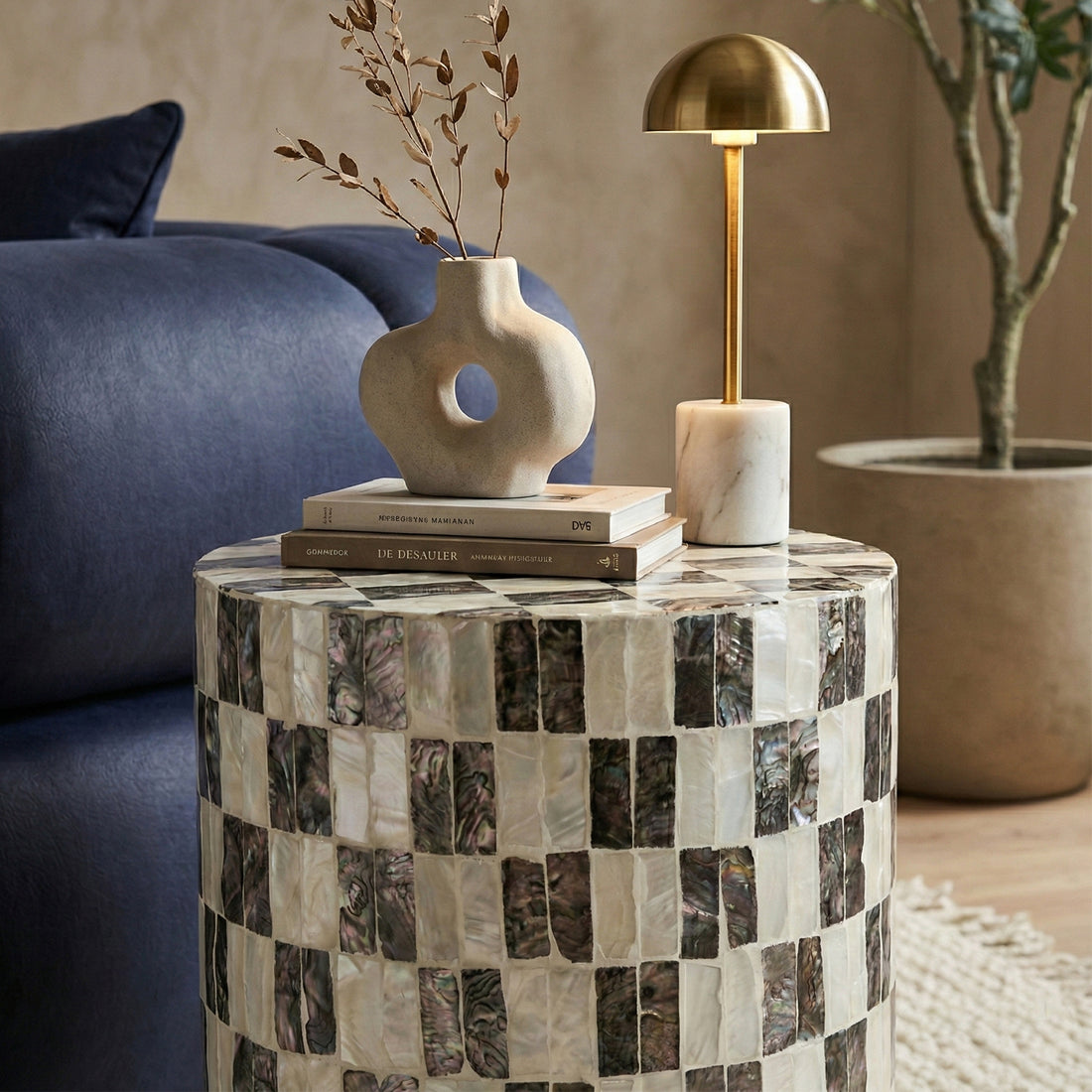 Checkered side table styled with vase, books, and lamp in living room