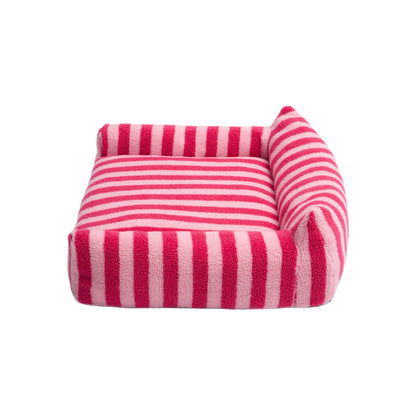 Plush pet bed with alternating hot pink and light pink stripes on a plain white background, full view