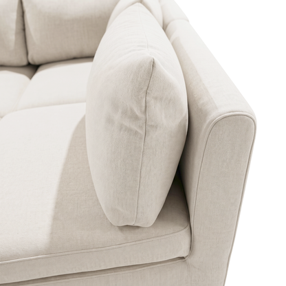 Close-up of cream sofa cushion, armrest, and textured upholstery