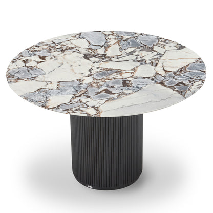Gracie 120cm Round Marble Dining Table features a white marble top with gray and brown veins, paired with a fluted black pedestal base, embodying modern elegance and stability.