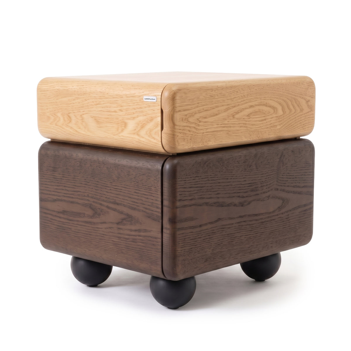 Modern two-tone wooden side table with rounded edges and black spherical feet on a white background