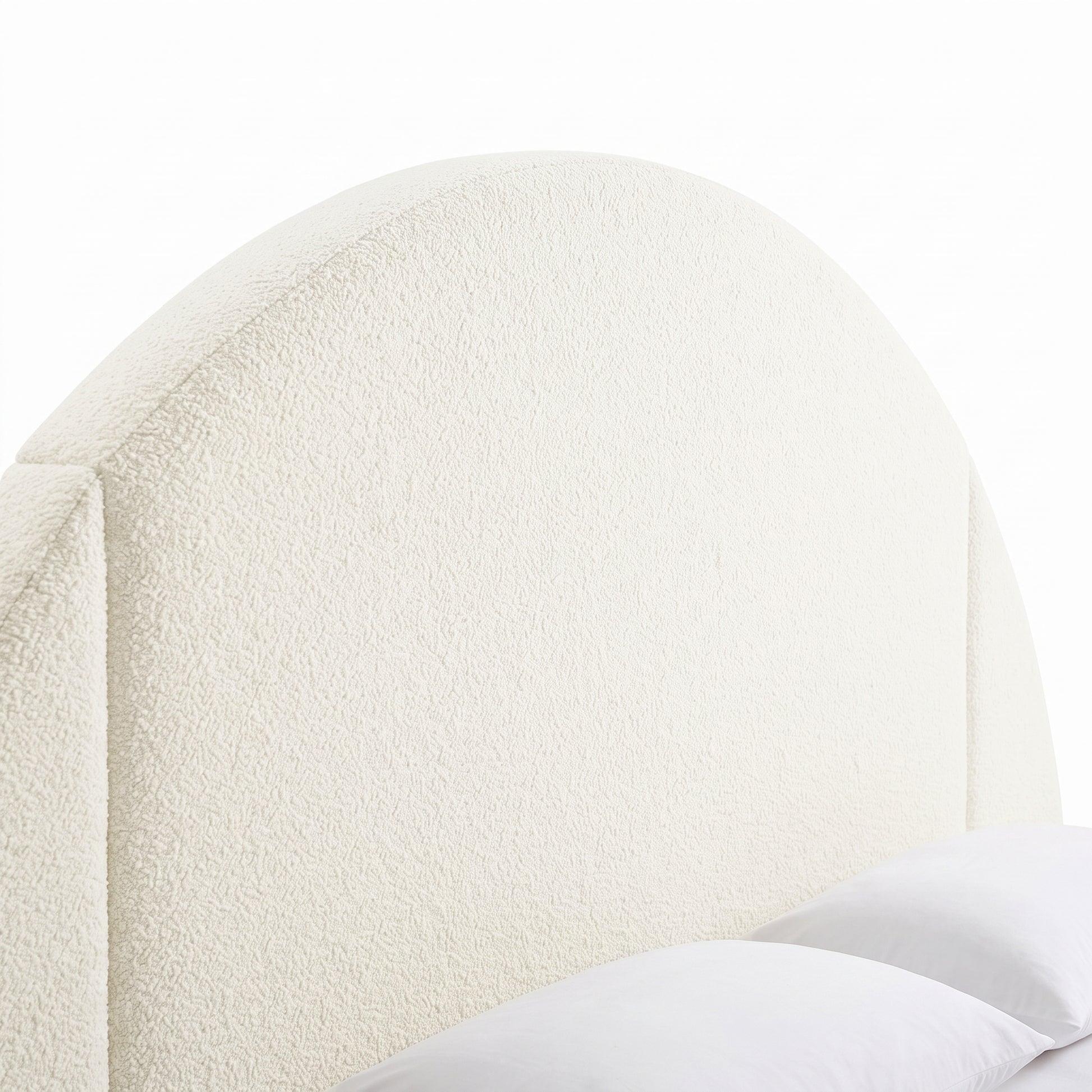 Close-up of an upholstered arched headboard on a white background
