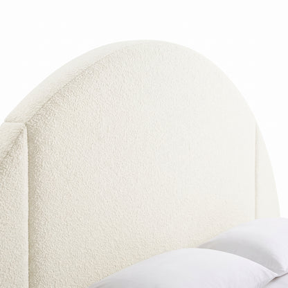 Close-up of an upholstered arched headboard on a white background