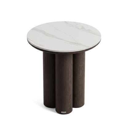 Round side table with white marble-look top and dark wood legs on white background