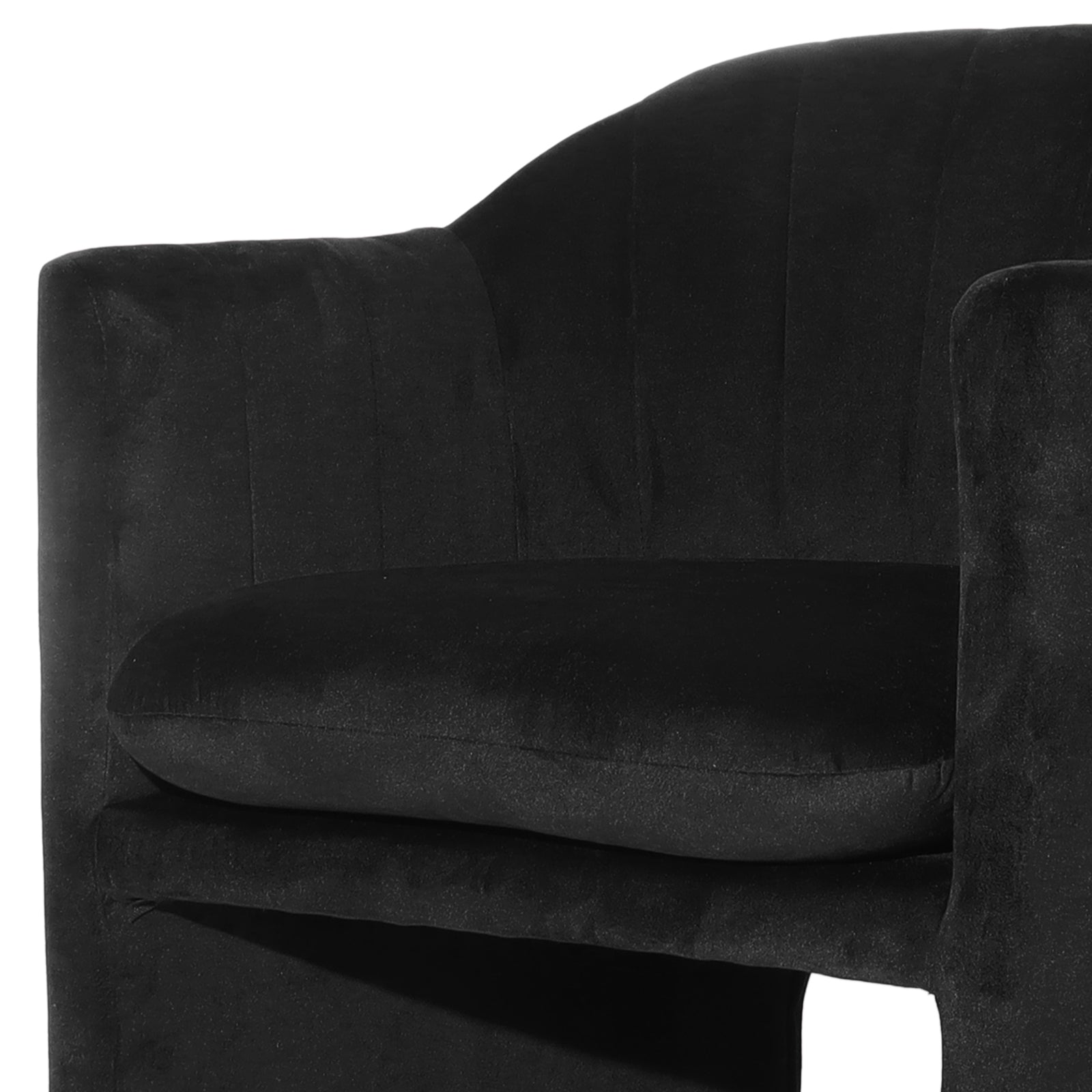 Close-up of the Liora Velvet Curved Accent Armchair in Black, showcasing the plush padded armrest, loose seat cushion, and elegantly curved, channel-stitched backrest, highlighting its sophisticated, sculptural design.