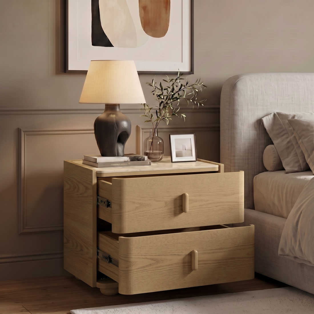 Light wood two-drawer nightstand styled beside a bed in a bedroom