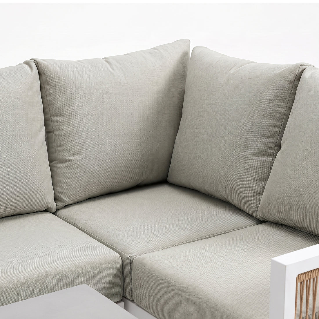 Corner section of an outdoor sectional sofa with light cushions on a white background