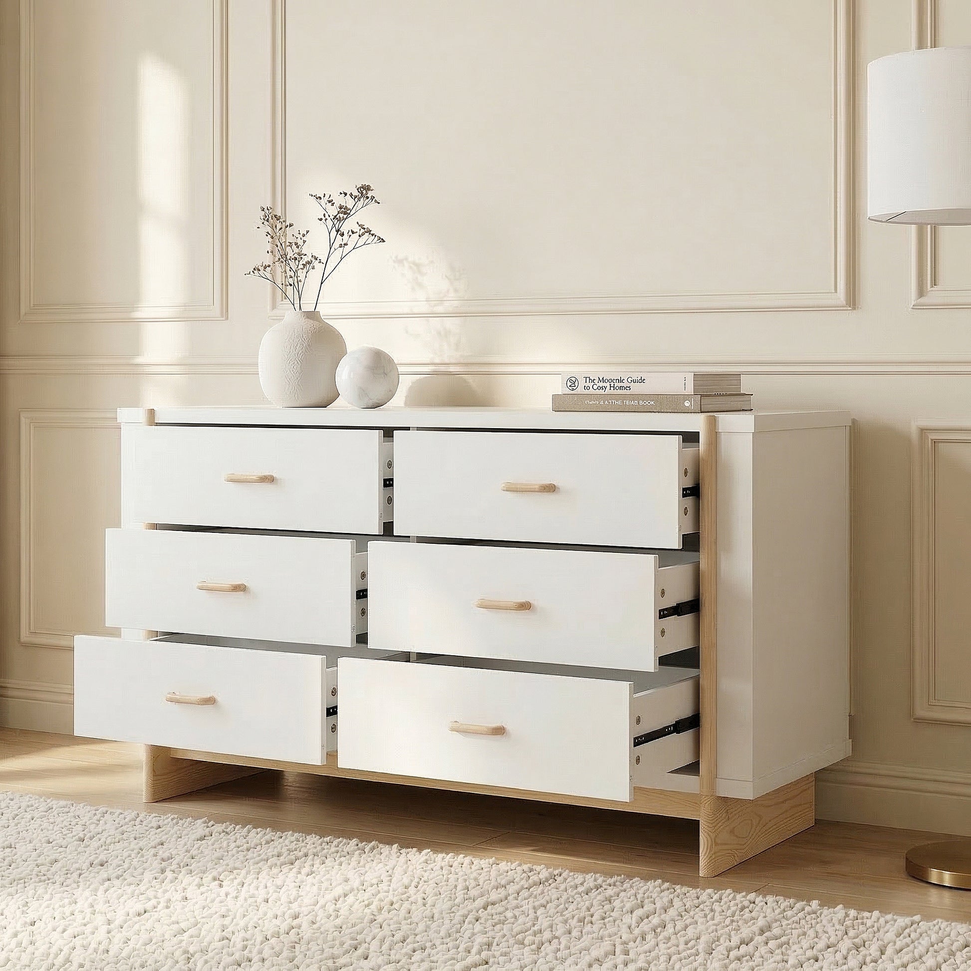 Modern dresser with partially open drawers styled in a bright room against paneled wall