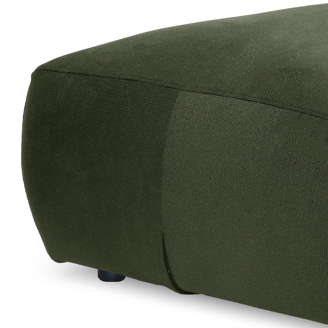 Close-up of green ottoman corner showing fabric texture