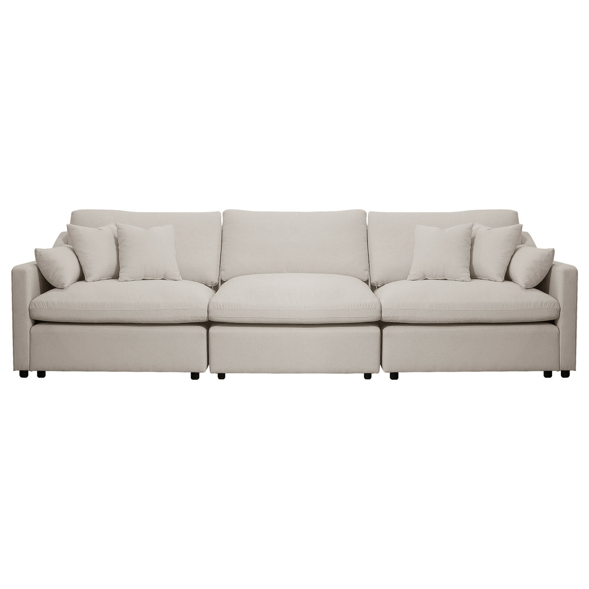 Beige three-seat sofa with five throw pillows on a white background