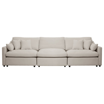 Beige three-seat sofa with five throw pillows on a white background