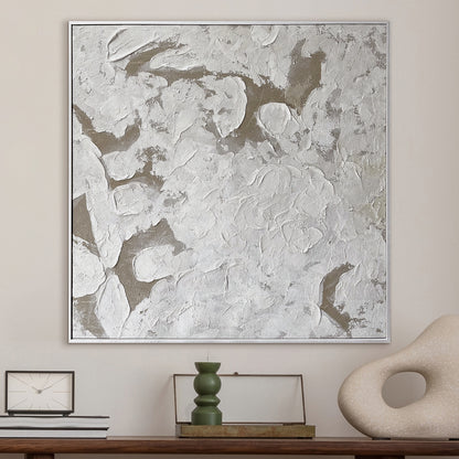 Luma Framed Canvas Wall Art 105 x 105cm in White, featuring an impasto off-white and taupe abstract design in a slim silver frame, styled above a modern wooden console with minimalist decor.