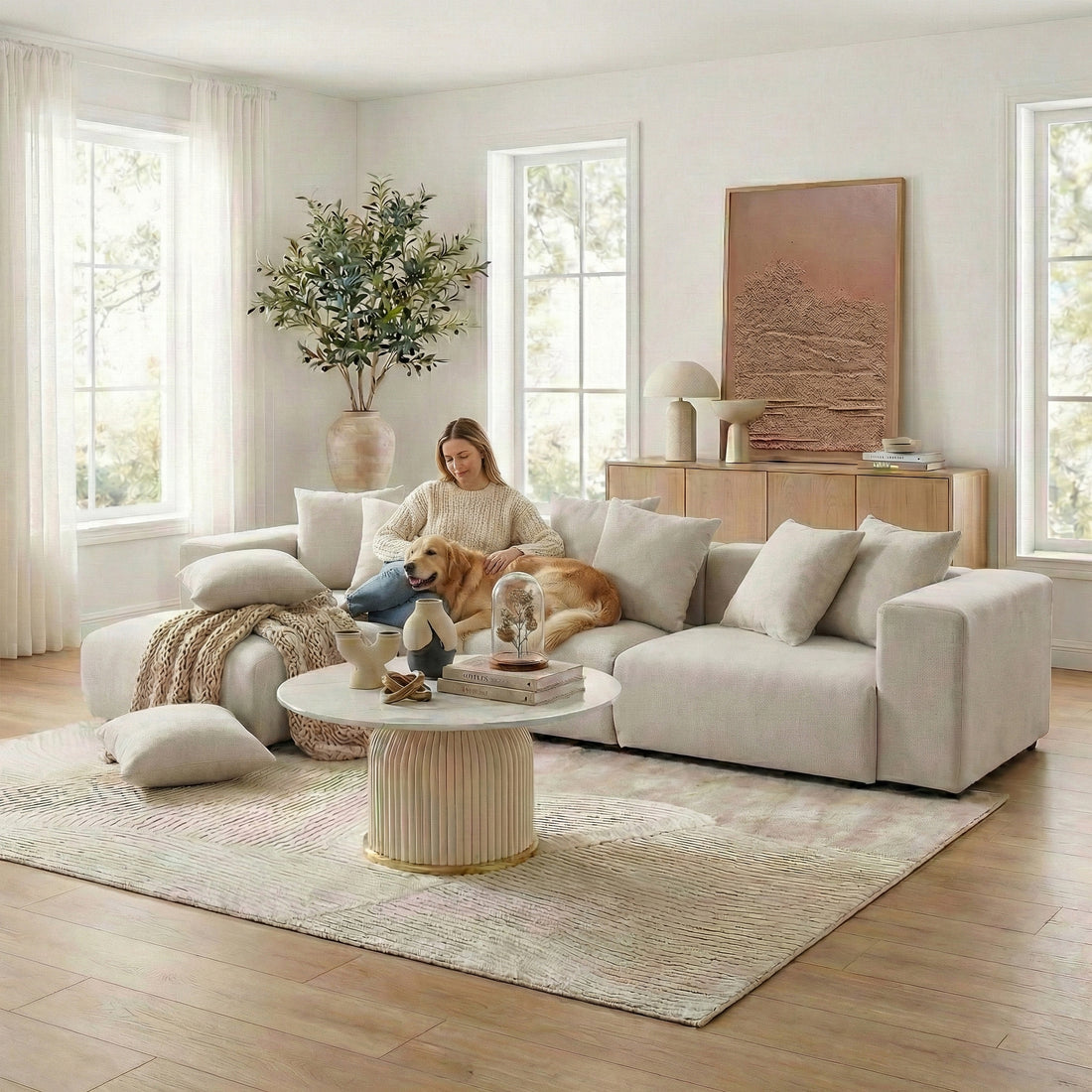 Beige sectional sofa in sunny living room with person and dog
