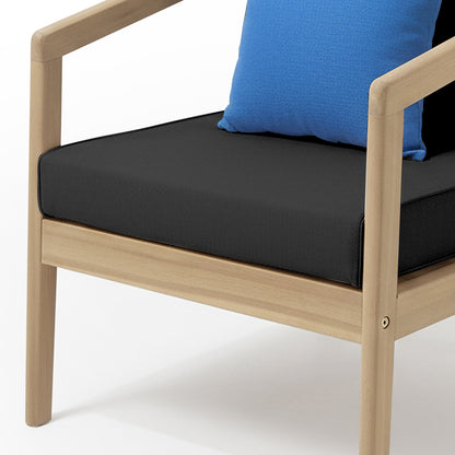 Delva 4 Seater Hardwood Acacia Outdoor Sofa Set in Black features a wooden-frame armchair with a black seat cushion and a blue throw pillow, highlighting its modern and inviting design.