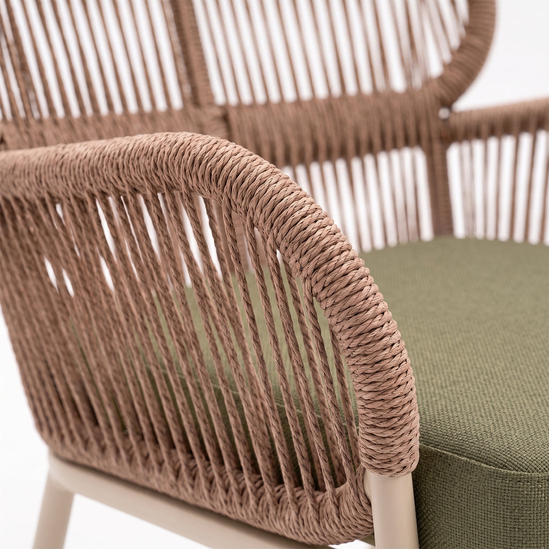 Close-up of woven chair detail with green cushion
