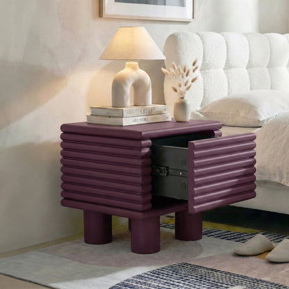 Burgundy ribbed nightstand in bedroom with open drawer
