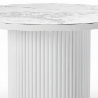 Evone Aluminium Outdoor Dining Table in White features a round, marble-look top with grey veining, supported by a cylindrical base with vertical grooves, offering stylish durability for outdoor dining.