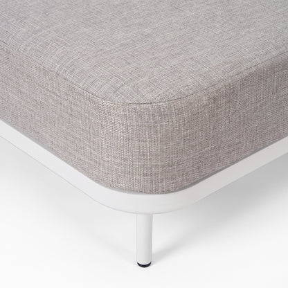 Close-up of the corner and leg of a modern upholstered furniture piece on a white background.