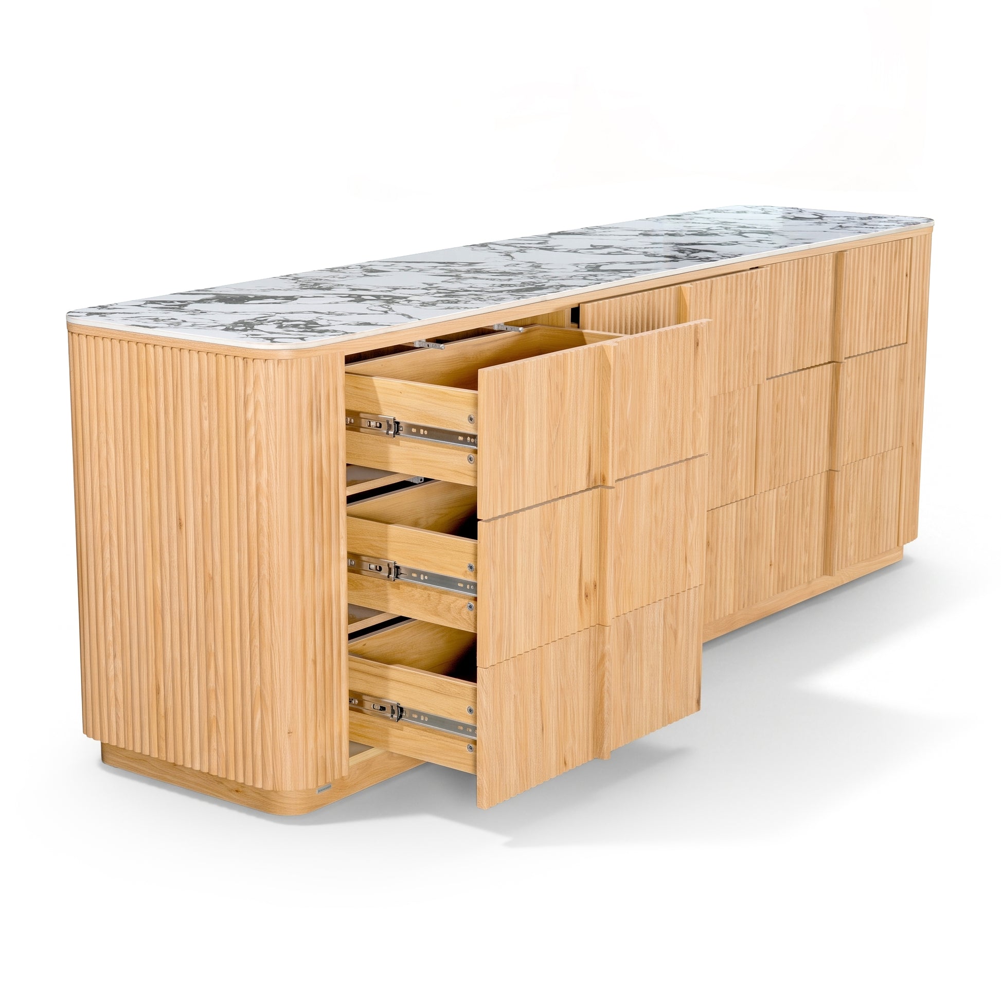 Light wood sideboard with marble top and partially open drawers on white background