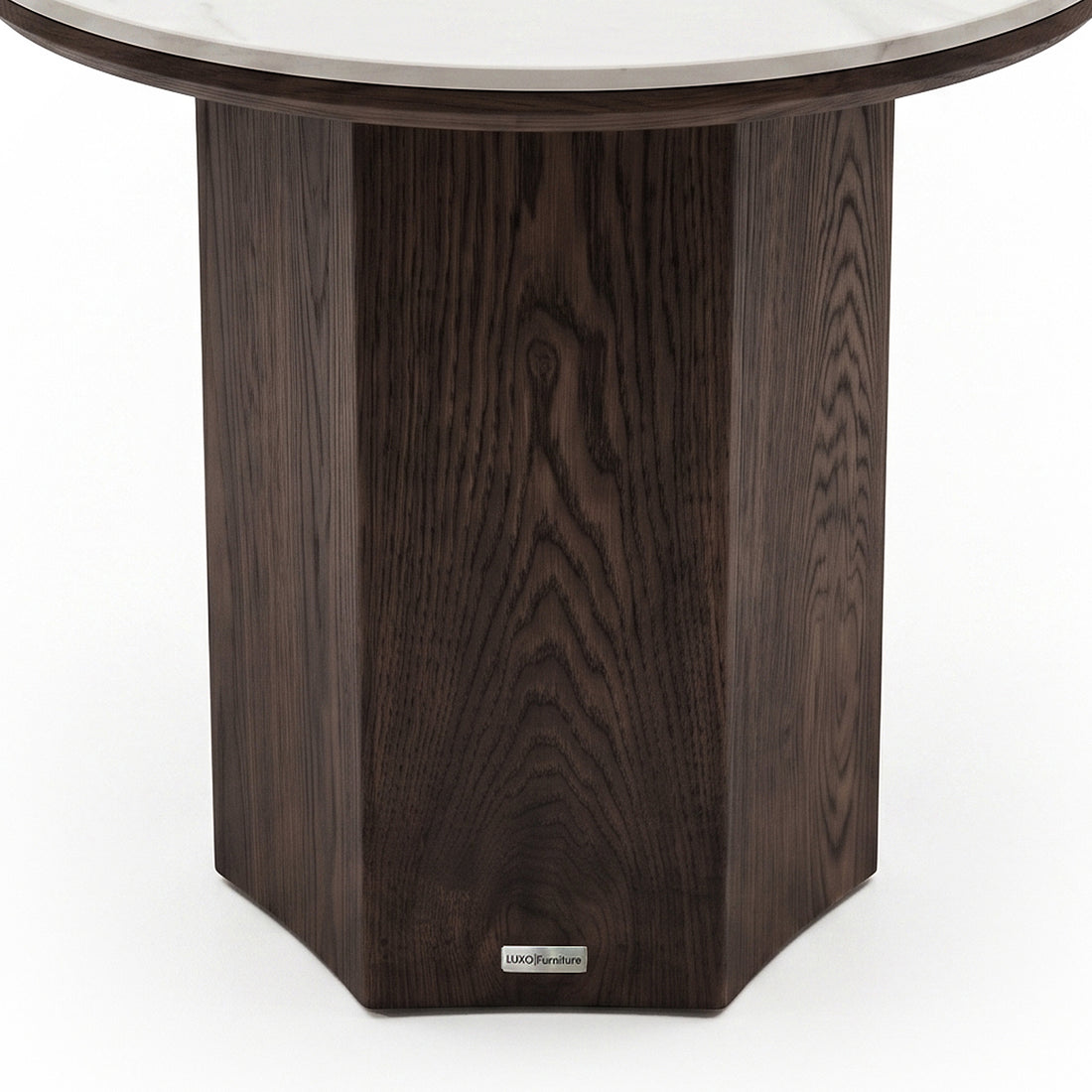 Partial close-up of a round table base with dark wood finish on a white background