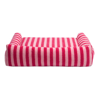 Pink and white striped rectangular pet bed with raised sides on a white background
