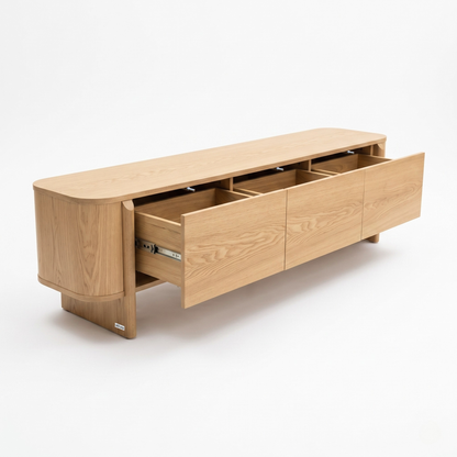 Light wood sideboard on a white background with three drawers partially open
