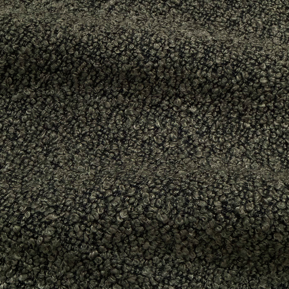 Extreme close-up of charcoal boucle fabric texture