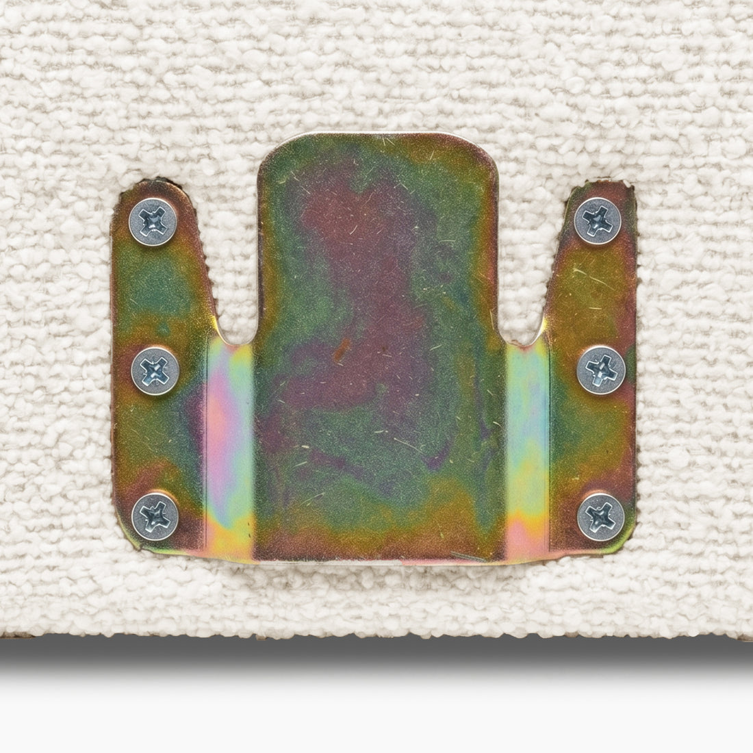 Close-up of metal mounting bracket attached to textured fabric surface