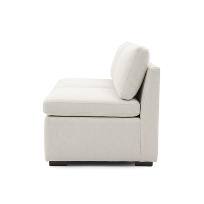 Side profile of a cream upholstered modular sofa section on white
