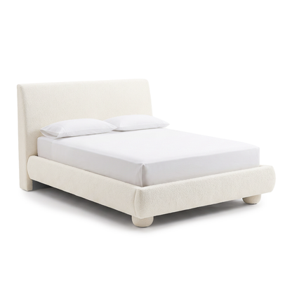 Angled view of a modern upholstered bed on a white background