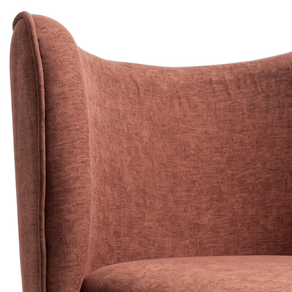 Close-up of the upper section of a terracotta upholstered chair on white background