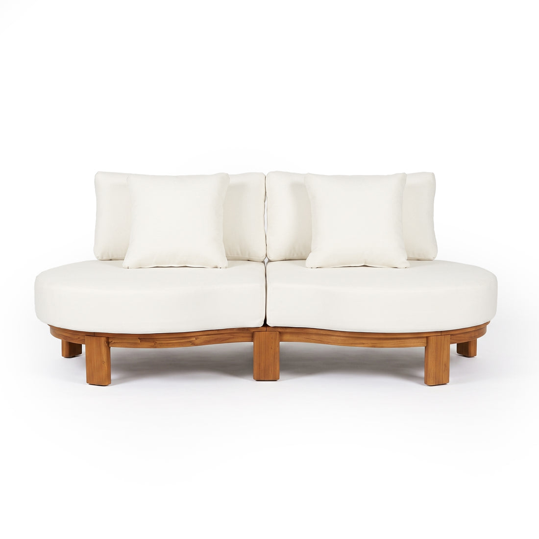 Modern two-piece curved sofa with wooden base and white pillows on a white background.