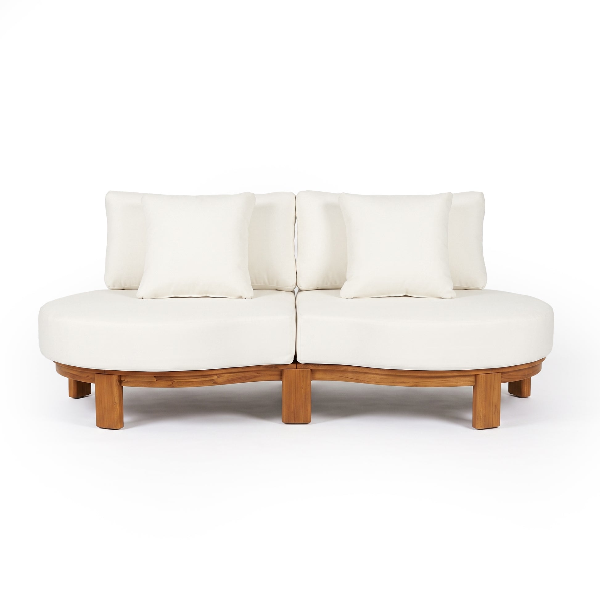 Modern two-piece curved sofa with wooden base and white pillows on a white background.