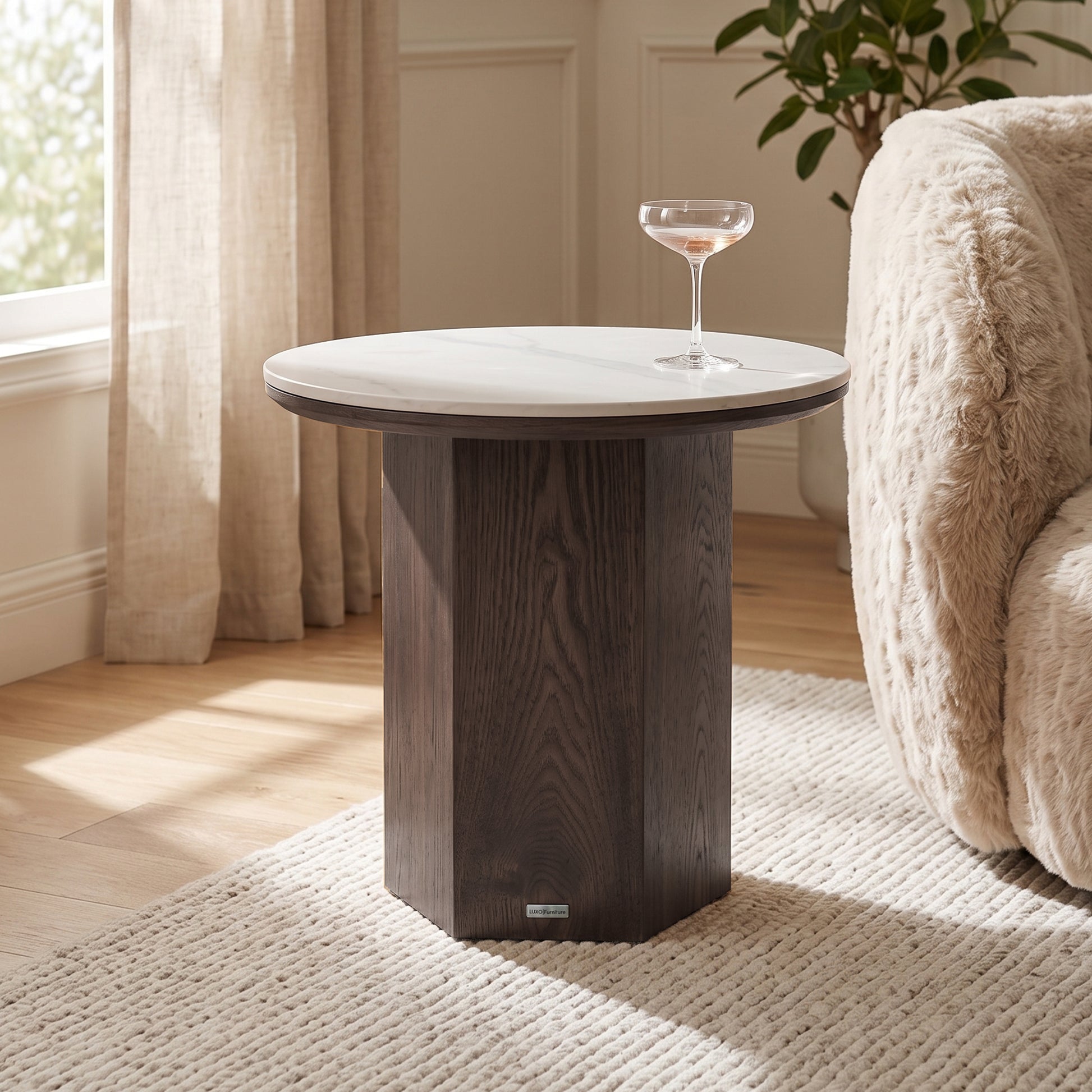 Round side table styled in a living room next to an armchair and rug