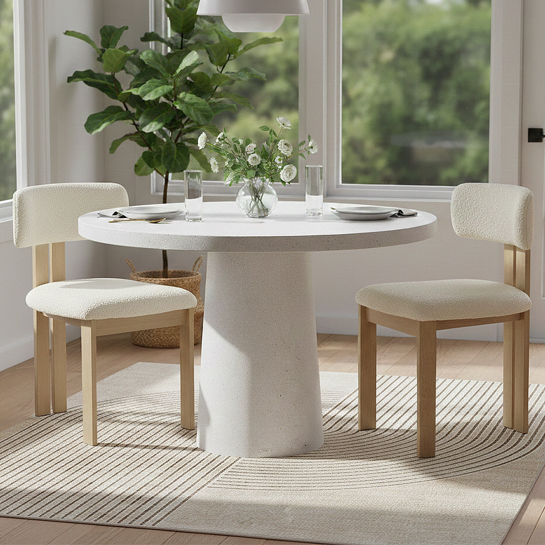 Round dining table with chairs in a bright, modern dining room