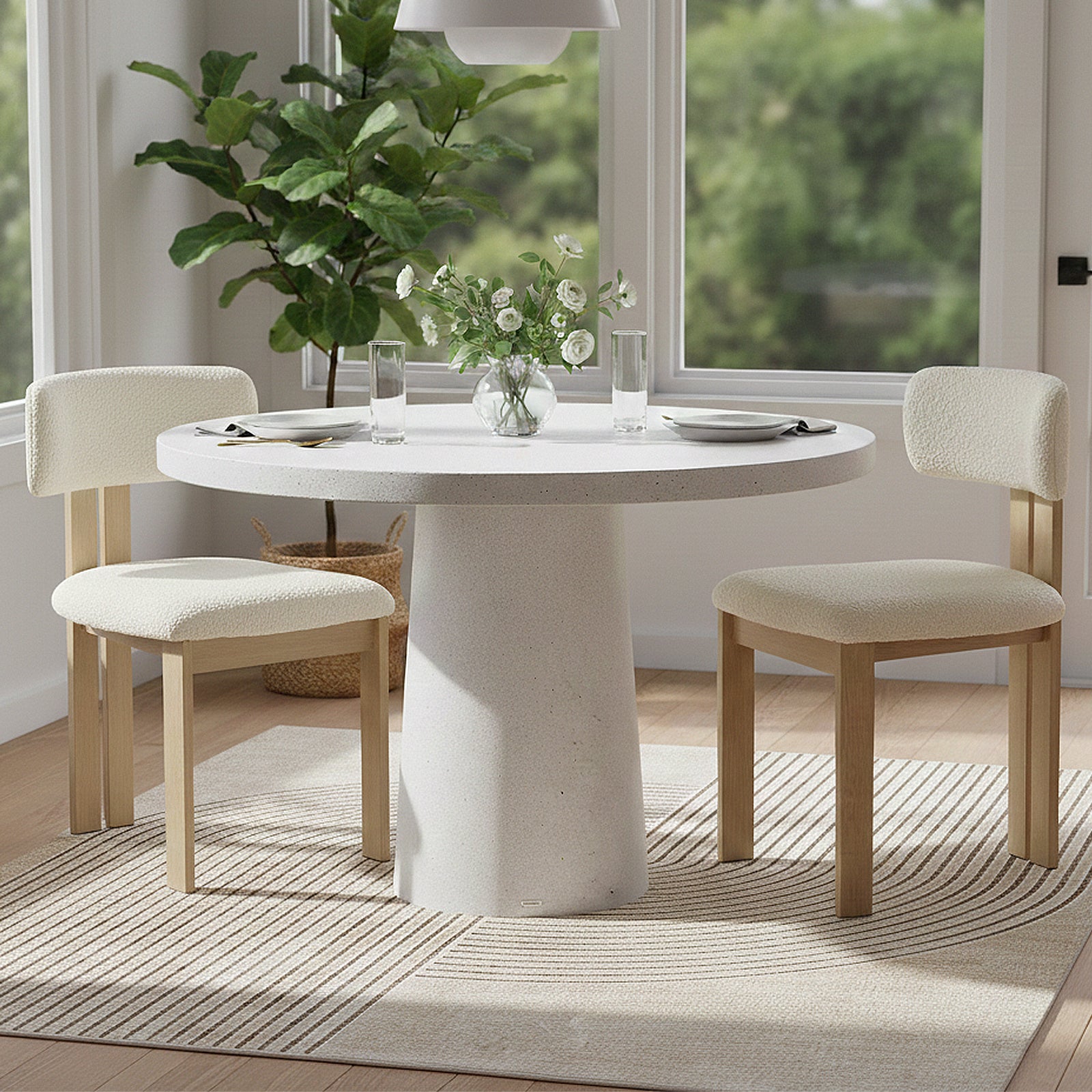 Round dining table with chairs in a bright, modern dining room