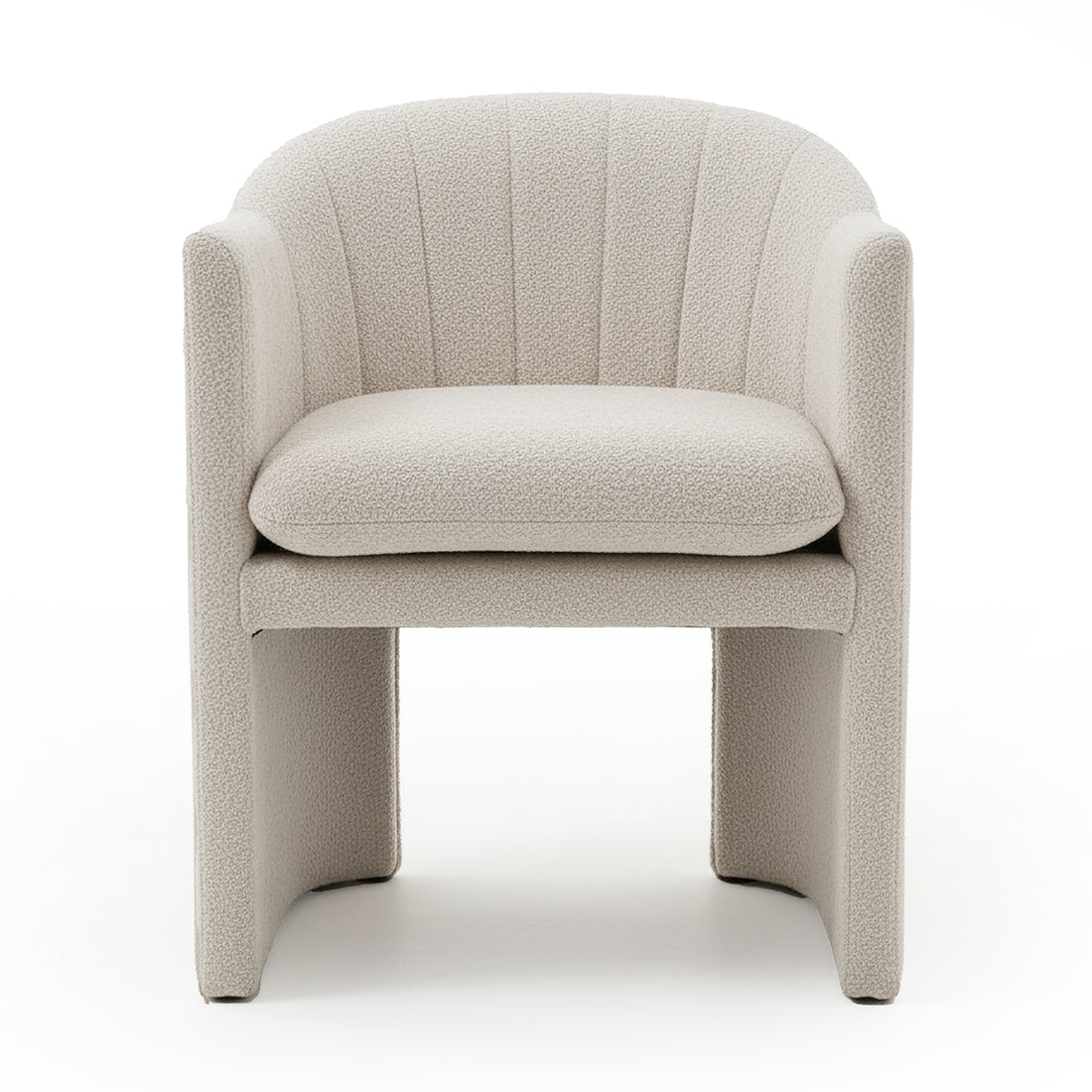 Liora Bouclé Curved Accent Armchair in Beige features a cream bouclé upholstery, curved channel-stitched back, low arms, thick removable cushion, and panel-style legs with arched opening underneath.