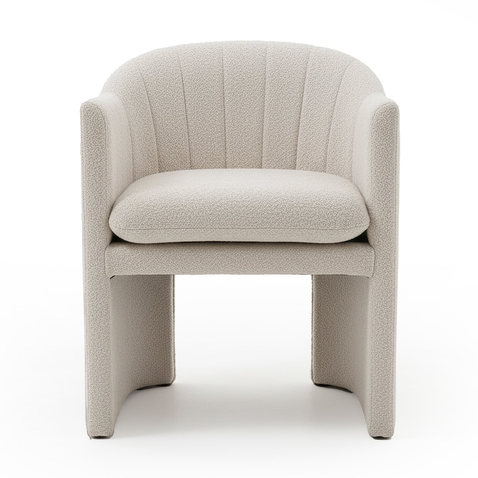 Liora Bouclé Curved Accent Armchair in Beige features a cream bouclé upholstery, curved channel-stitched back, low arms, thick removable cushion, and panel-style legs with arched opening underneath.