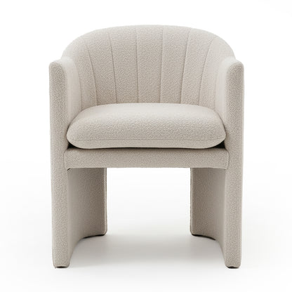 Liora Bouclé Curved Accent Armchair in Beige features a cream bouclé upholstery, curved channel-stitched back, low arms, thick removable cushion, and panel-style legs with arched opening underneath.