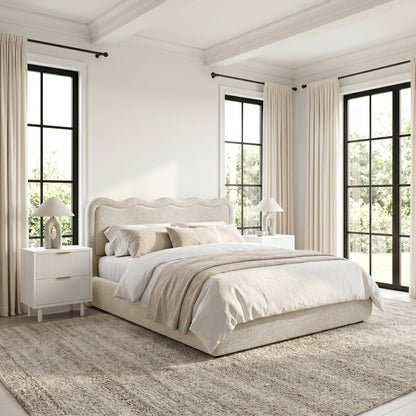 Upholstered bed in styled bedroom with neutral decor
