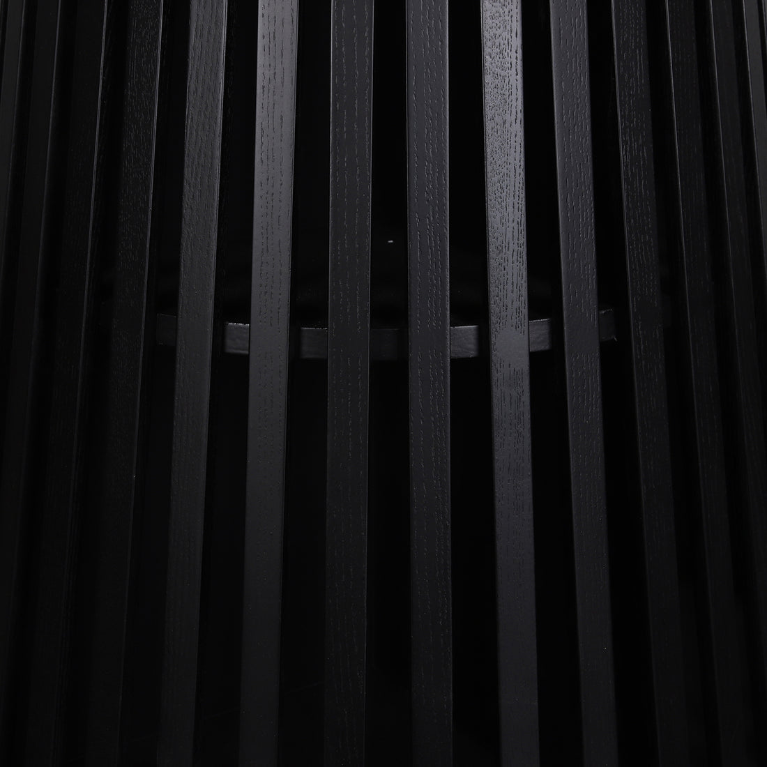 Close-up of the Riri 120cm Round Fluted Wood Dining Table in Black, featuring vertical black wooden slats forming a sleek, textured cylindrical base, highlighting its modern, sculptural design.