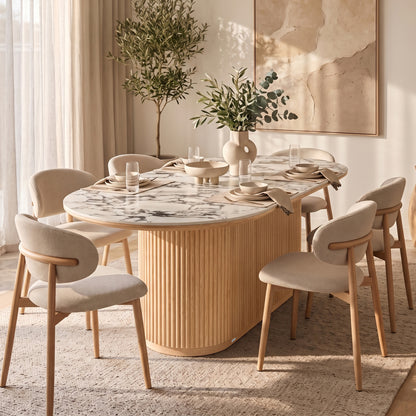 Modern dining room with oval marble-top table, six chairs, and decorative styling