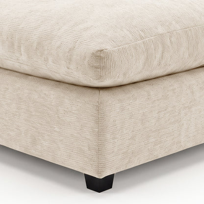Close-up of beige upholstered furniture corner with visible stitching