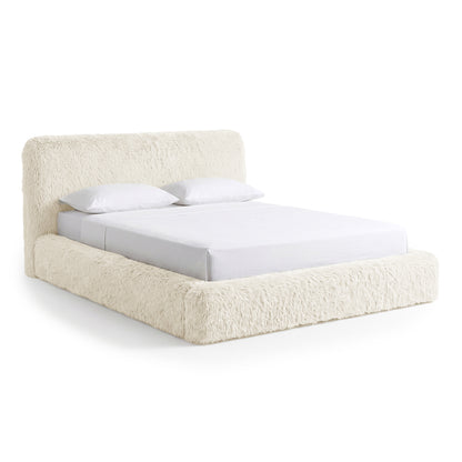 Modern plush cream bed on a white background.
