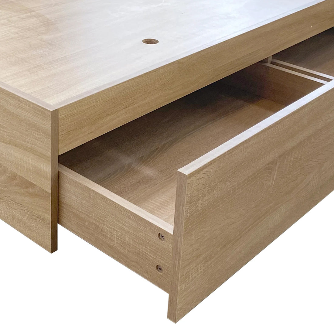 Eulalia King Platform Bed Base with Drawers in Oak, featuring a handle-less, light oak-finish drawer with a cable-management hole, partially extended, showcasing its modern, streamlined design for efficient under-bed storage.