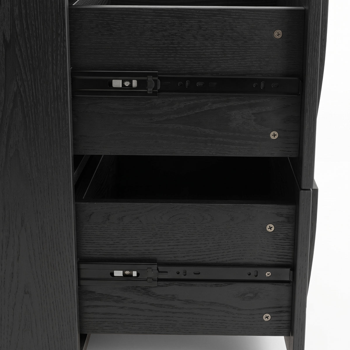 Close-up side view of a black wood cabinet with partially open drawers