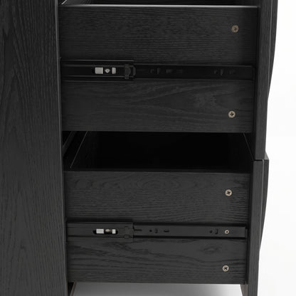 Close-up side view of a black wood cabinet with partially open drawers