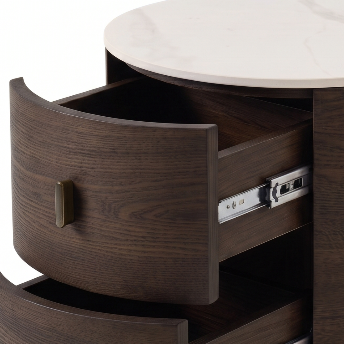 Close-up of a round wooden nightstand with partially open drawers and brass handles.