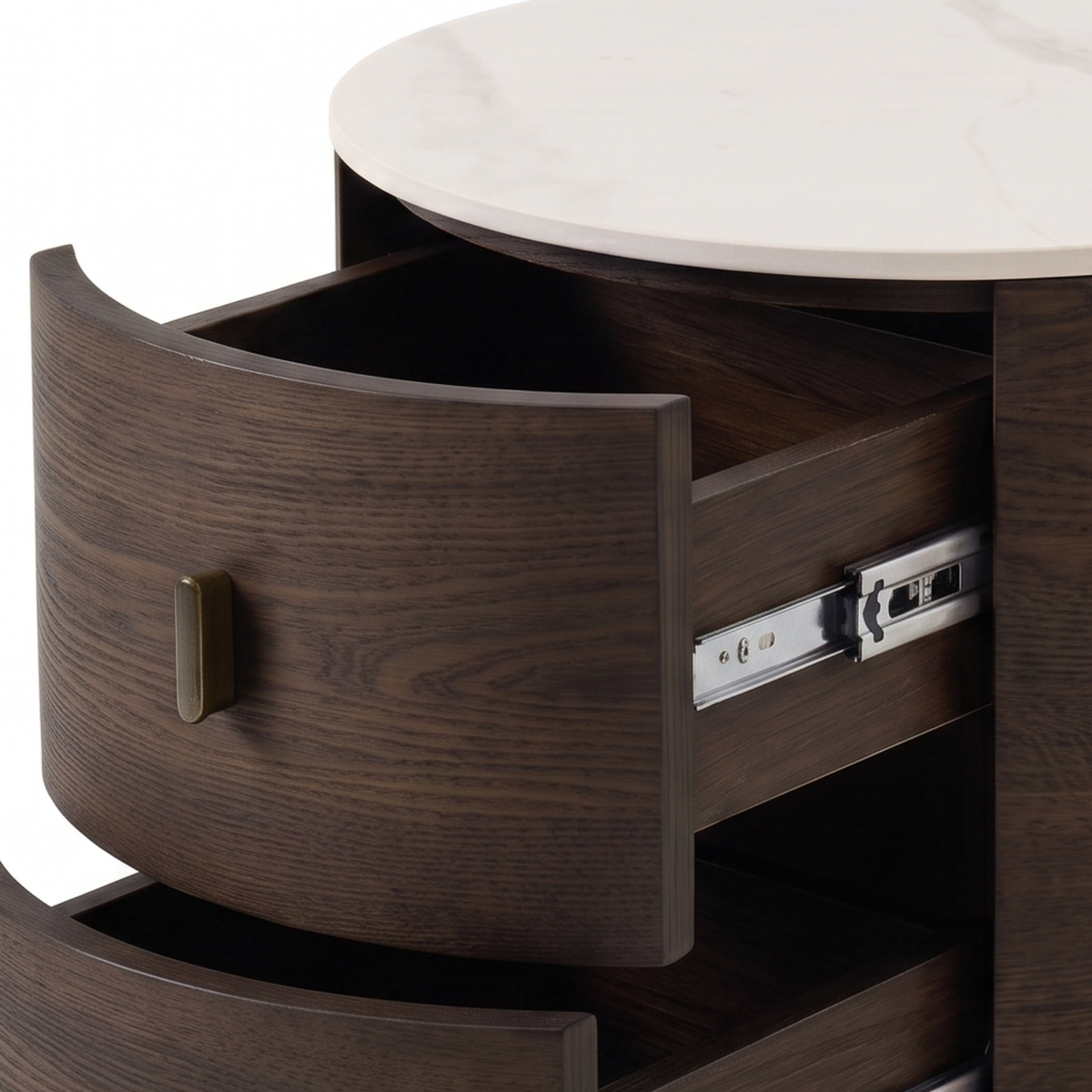 Close-up of a round wooden nightstand with partially open drawers and brass handles.